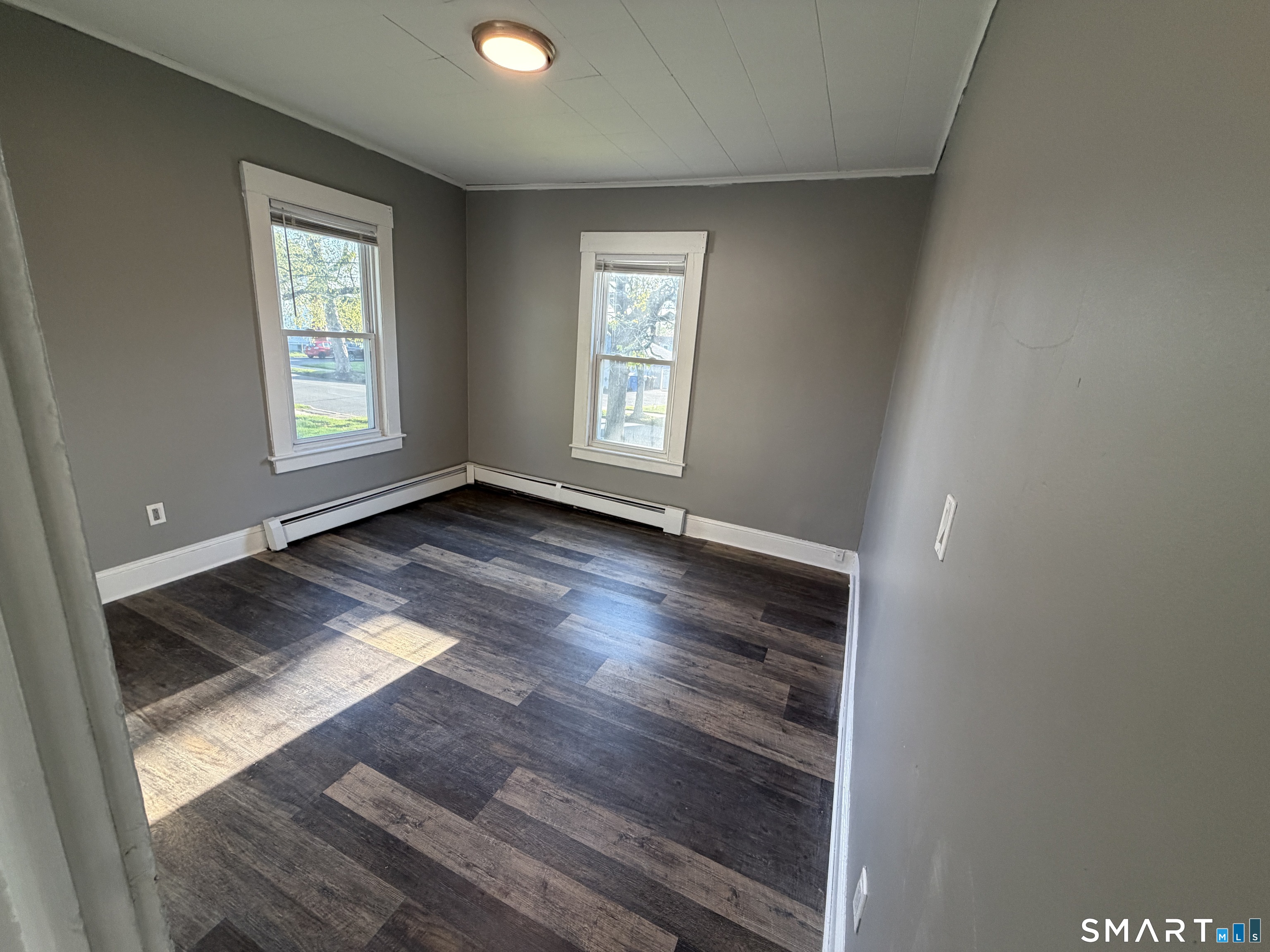 402 Allen Street New Britain, CT 06053 - Photo 10 of 14 an empty room with wooden floor and windows