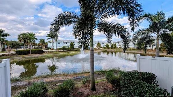 a view of a lake with palm trees
