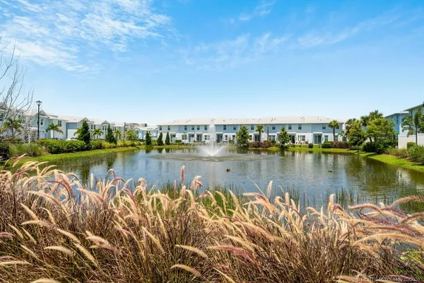 a view of a lake with houses in the back