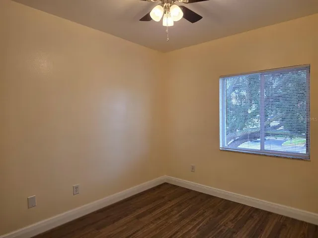 a view of a small space with wooden floor and a window