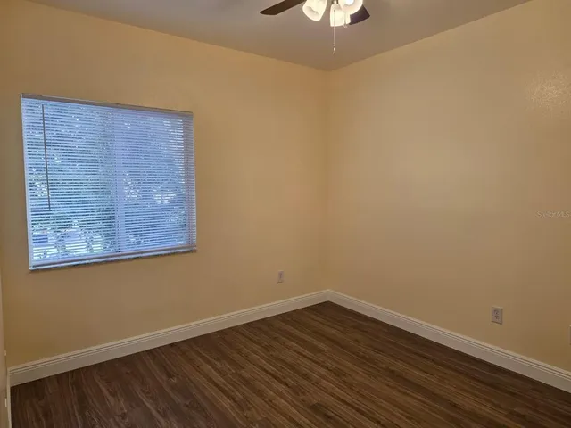 a view of a room with wooden floor and closet