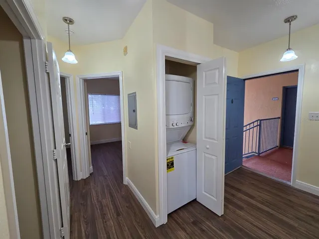 a view of a hallway with wooden floor and staircase