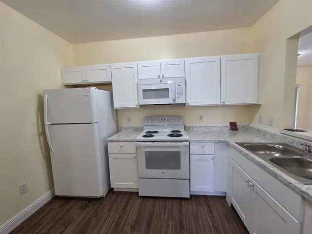 a kitchen with a stove a refrigerator and a sink