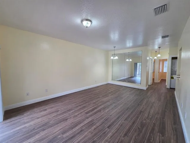 a view of a room with wooden floor