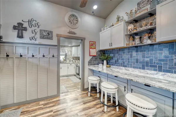 a bathroom with a granite countertop toilet sink and mirror