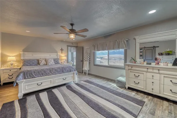 a bedroom with a large bed and a dresser