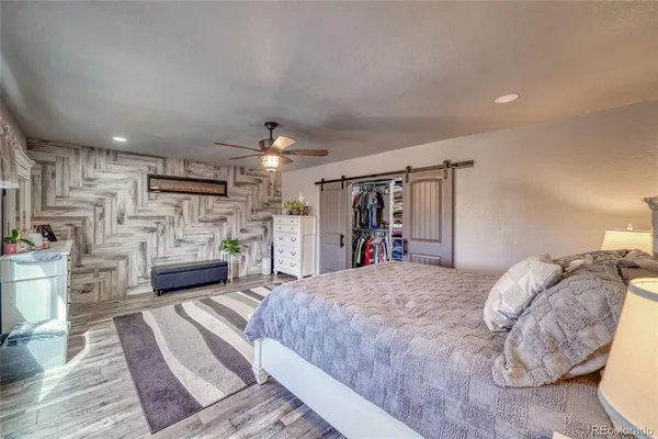 a bed room with furniture and a flat screen tv