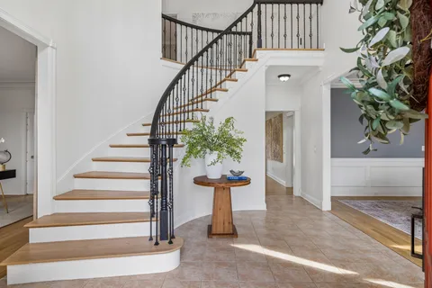 a view of entryway and hall with wooden floor
