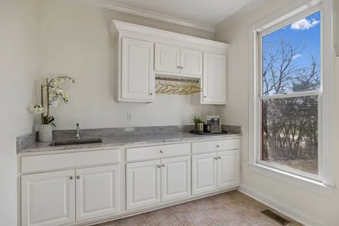 a spacious bathroom with a granite countertop sink a mirror and a shower