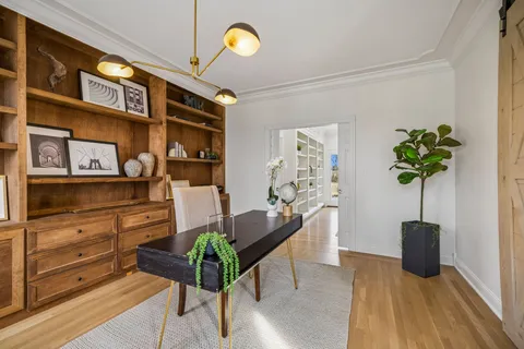 a living room with furniture and a chandelier