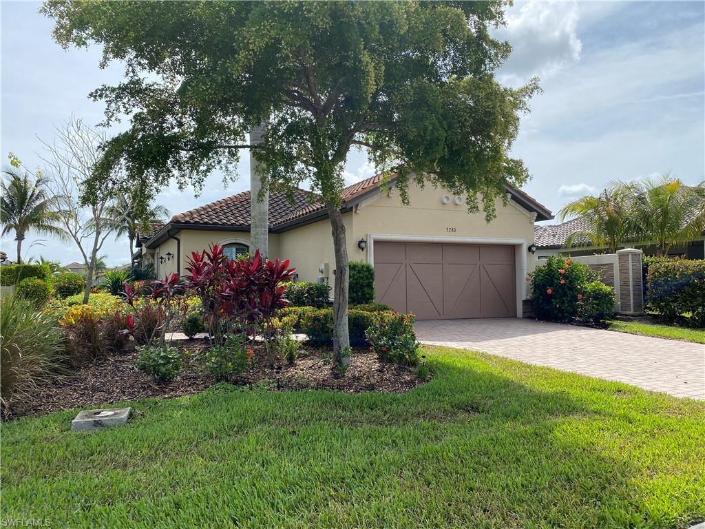 3280 Miyagi Lane Naples, FL 34114 - Photo 1 of 25 a front view of house with a garden
