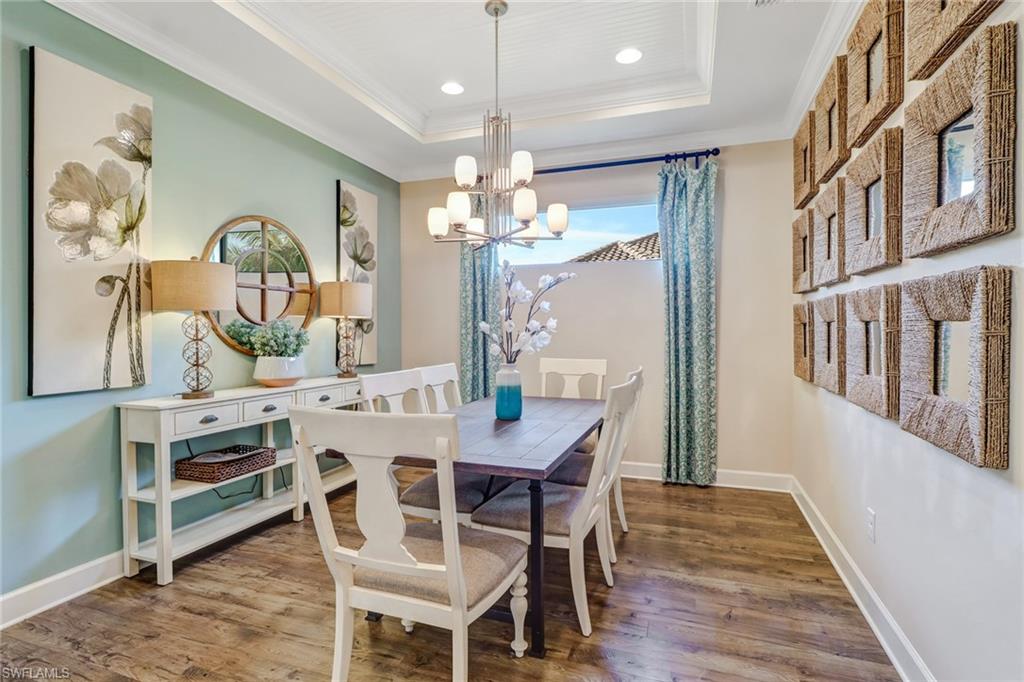 3280 Miyagi Lane Naples, FL 34114 - Photo 11 of 25 a view of a dining room with furniture and chandelier