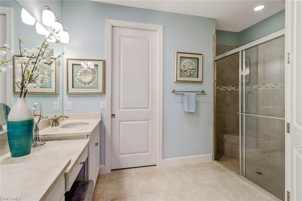 3280 Miyagi Lane Naples, FL 34114 - Photo 14 of 25 a bathroom with a sink mirror and a shower