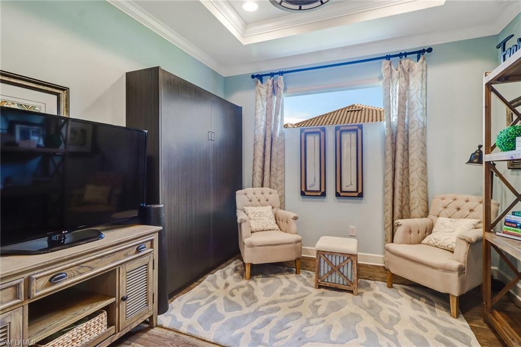 3280 Miyagi Lane Naples, FL 34114 - Photo 16 of 25 a living room with furniture and a fireplace