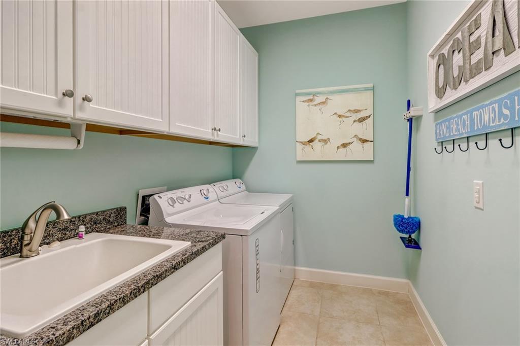 3280 Miyagi Lane Naples, FL 34114 - Photo 20 of 25 a bathroom with a sink and cabinets