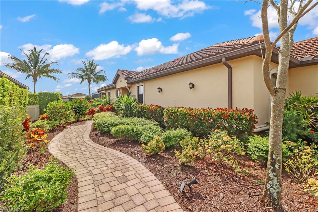 3280 Miyagi Lane Naples, FL 34114 - Photo 2 of 25 a front view of a house with a yard