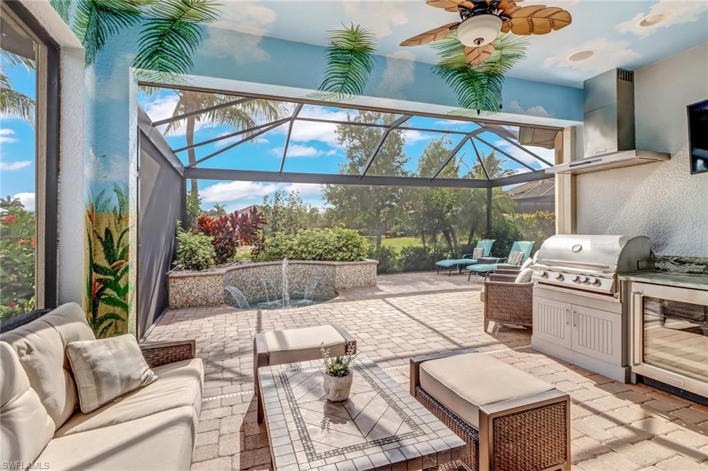 3280 Miyagi Lane Naples, FL 34114 - Photo 21 of 25 a living room with furniture a chandelier and a floor to ceiling window