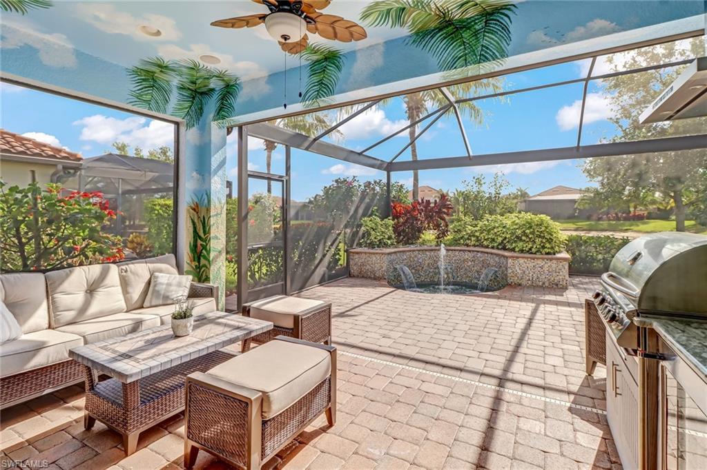 3280 Miyagi Lane Naples, FL 34114 - Photo 3 of 25 a view of a patio with a table and chairs under an umbrella