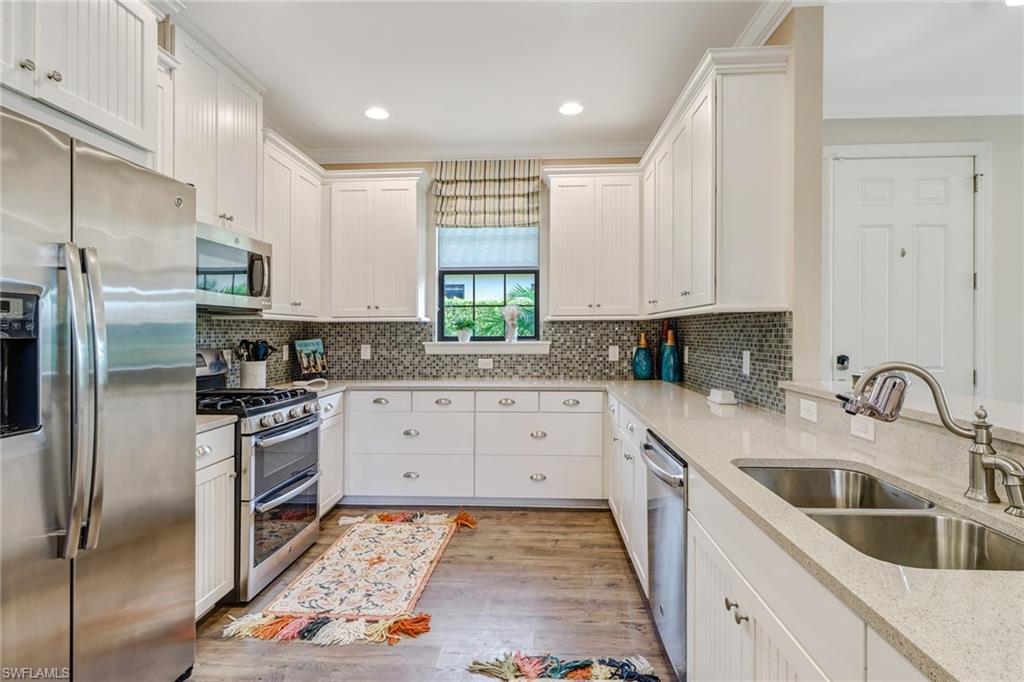 3280 Miyagi Lane Naples, FL 34114 - Photo 6 of 25 a kitchen with granite countertop a sink stainless steel appliances and cabinets