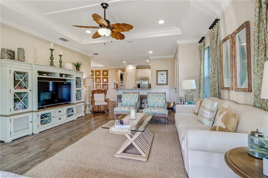 3280 Miyagi Lane Naples, FL 34114 - Photo 10 of 25 a living room with furniture a flat screen tv and a fireplace