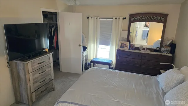 a bedroom with a bed and a flat screen tv