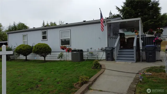 a view of a porch with furniture and a yard