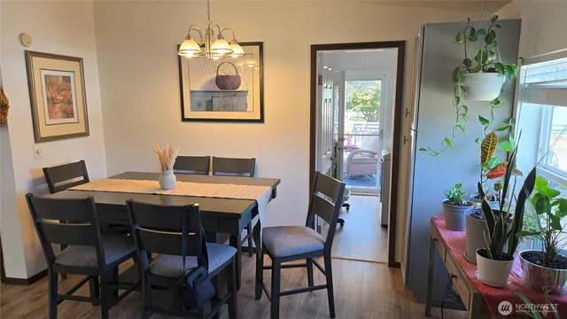 a dining room with furniture and wooden floor