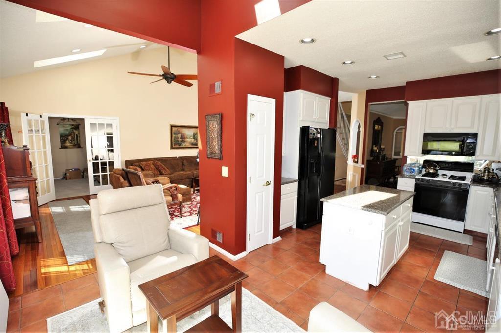 49 Harwood Road Monroe Township, NJ 08831 - Photo 15 of 73 a living room with furniture and a flat screen tv