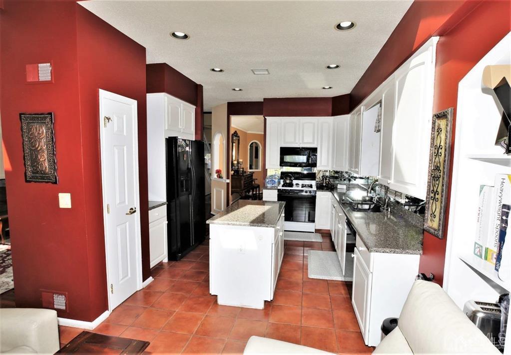 49 Harwood Road Monroe Township, NJ 08831 - Photo 16 of 73 a kitchen with refrigerator and microwave