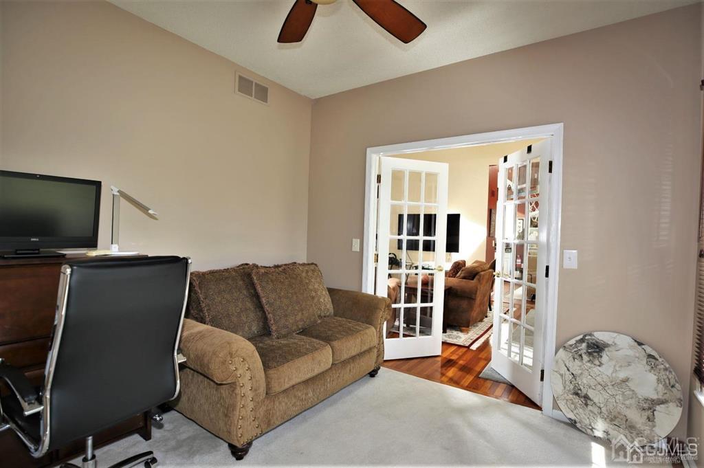 49 Harwood Road Monroe Township, NJ 08831 - Photo 22 of 73 a living room with furniture and a flat screen tv