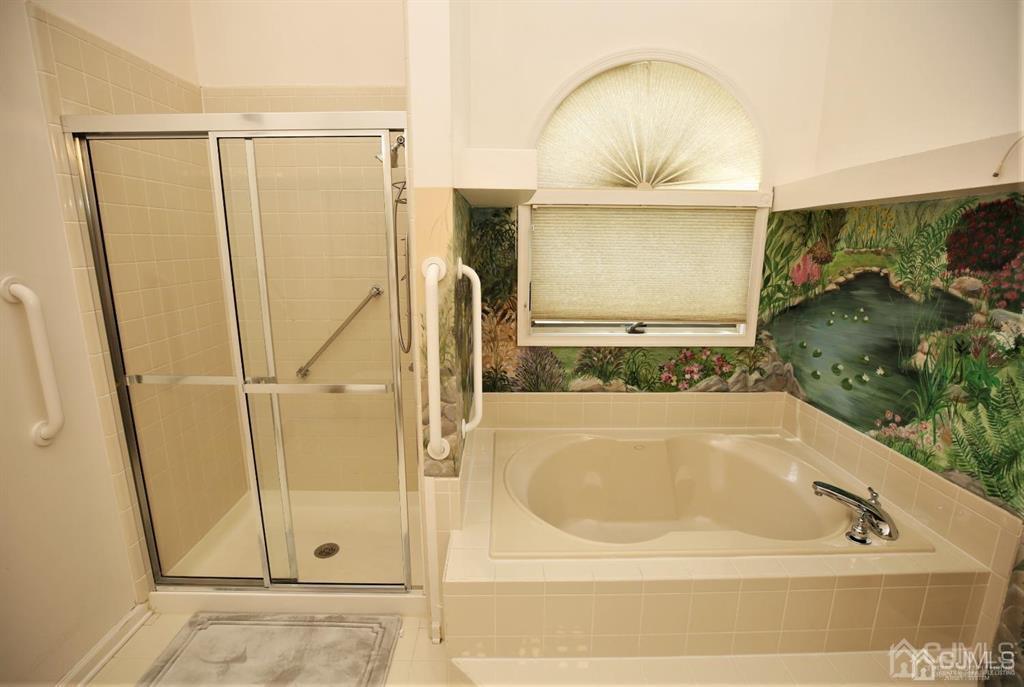 49 Harwood Road Monroe Township, NJ 08831 - Photo 29 of 73 a bathroom with a tub and shower
