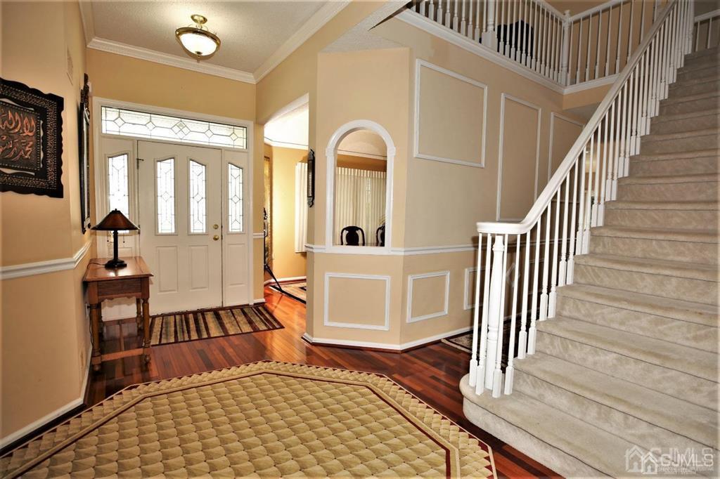 49 Harwood Road Monroe Township, NJ 08831 - Photo 3 of 73 a view of a hallway with wooden floor and staircase