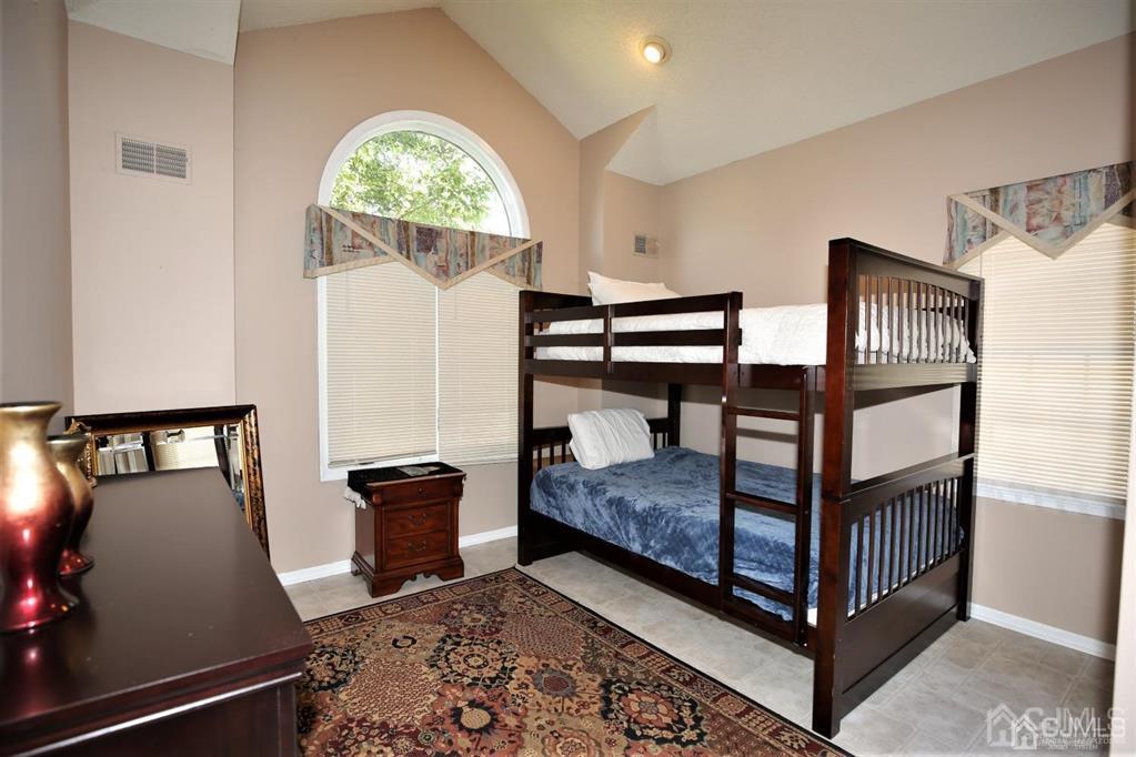 49 Harwood Road Monroe Township, NJ 08831 - Photo 31 of 73 a bedroom with a bed and wooden floor