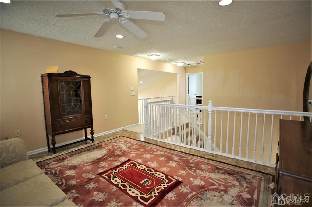 49 Harwood Road Monroe Township, NJ 08831 - Photo 37 of 73 a view of a bedroom with wooden floor & a ceiling fan