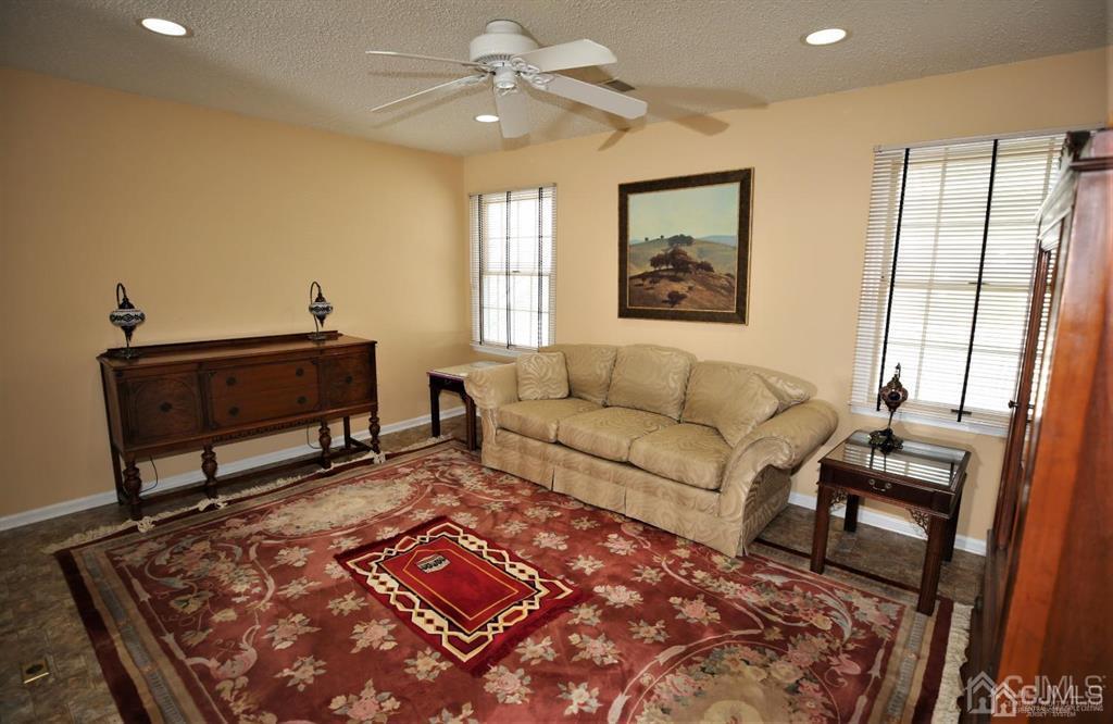 49 Harwood Road Monroe Township, NJ 08831 - Photo 38 of 73 a living room with furniture and a rug