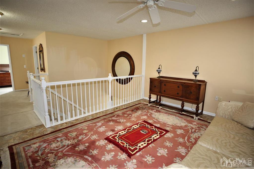 49 Harwood Road Monroe Township, NJ 08831 - Photo 39 of 73 a living room with a rug and a rug