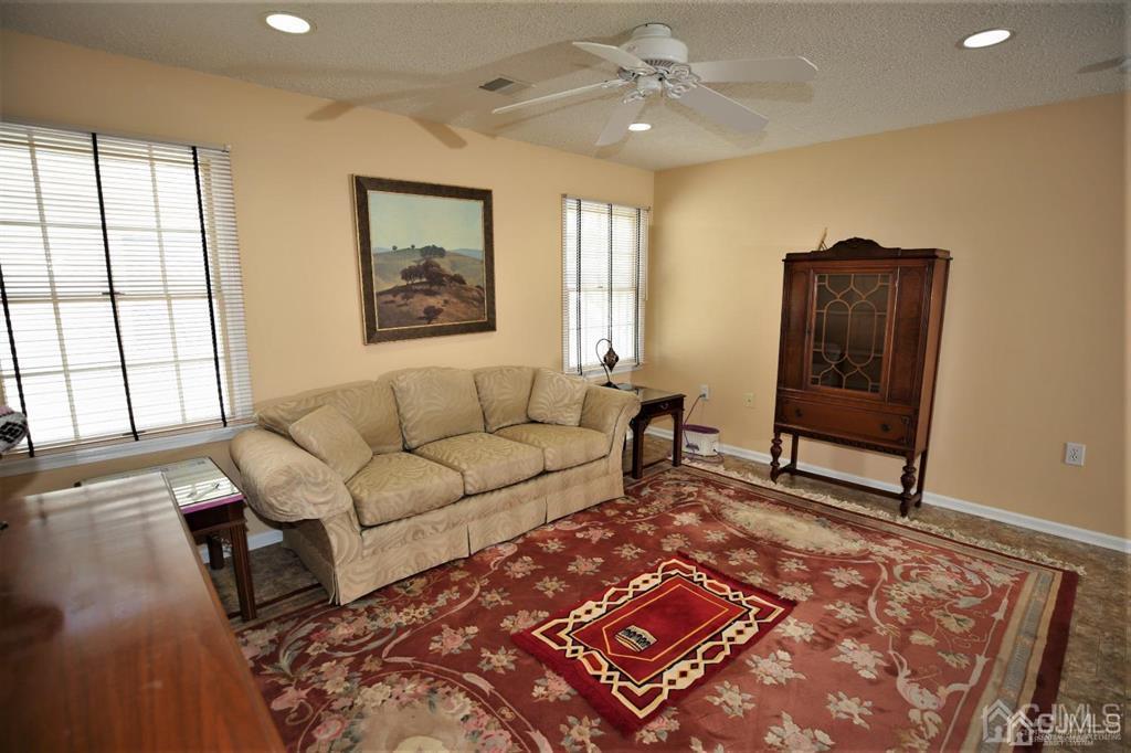 49 Harwood Road Monroe Township, NJ 08831 - Photo 40 of 73 a living room with furniture and a window