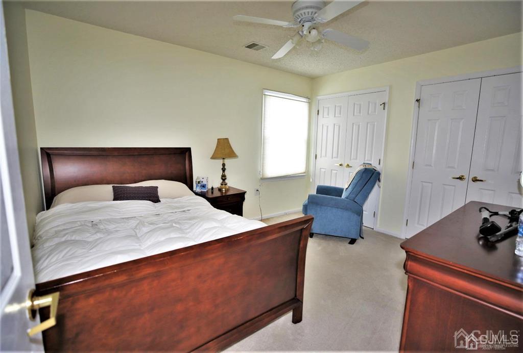49 Harwood Road Monroe Township, NJ 08831 - Photo 41 of 73 a bedroom with a bed and a dresser in it