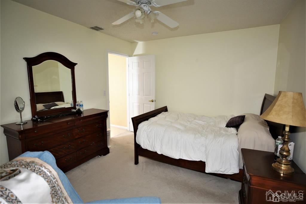 49 Harwood Road Monroe Township, NJ 08831 - Photo 42 of 73 a bedroom with a bed and a table
