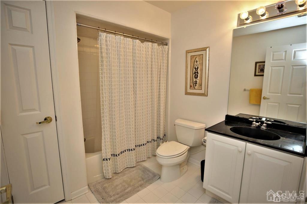 49 Harwood Road Monroe Township, NJ 08831 - Photo 43 of 73 a bathroom with a granite countertop sink and a toilet