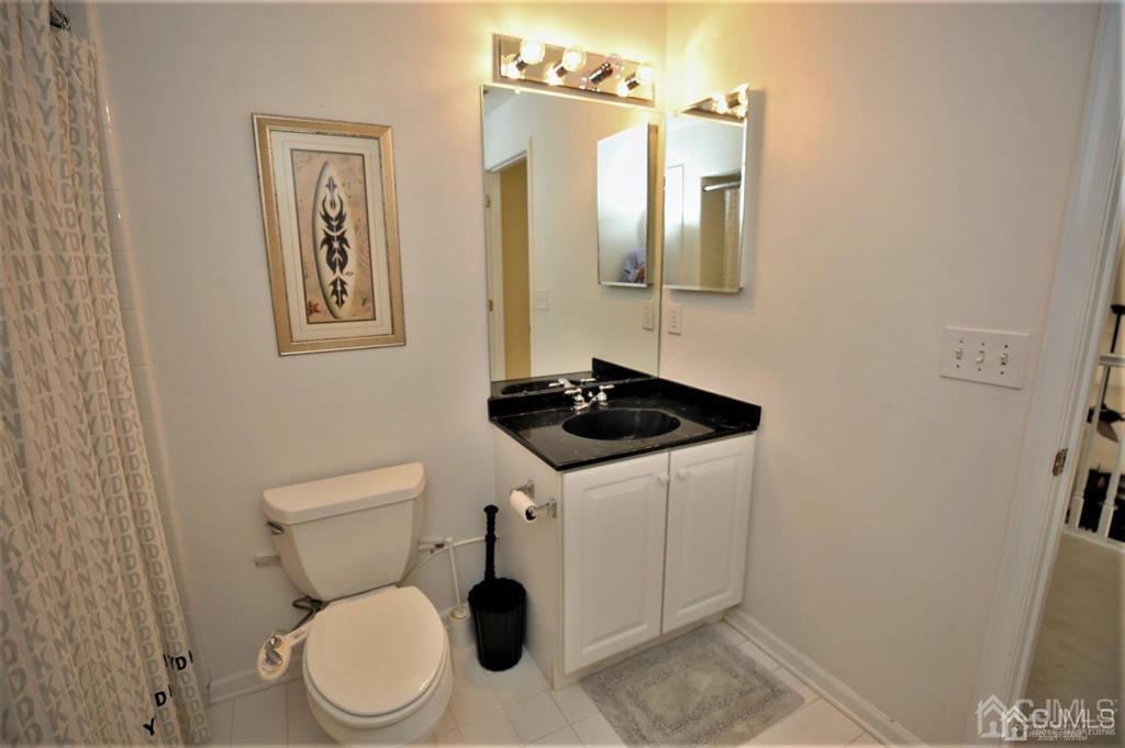 49 Harwood Road Monroe Township, NJ 08831 - Photo 44 of 73 a bathroom with a toilet a sink and mirror