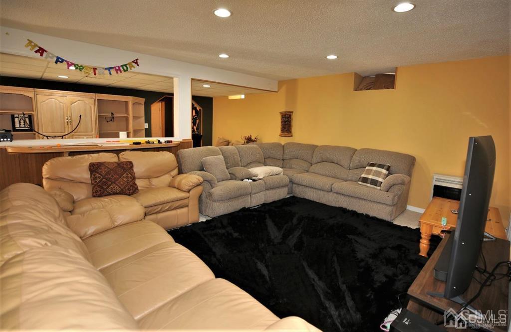 49 Harwood Road Monroe Township, NJ 08831 - Photo 45 of 73 a living room with furniture and a couch