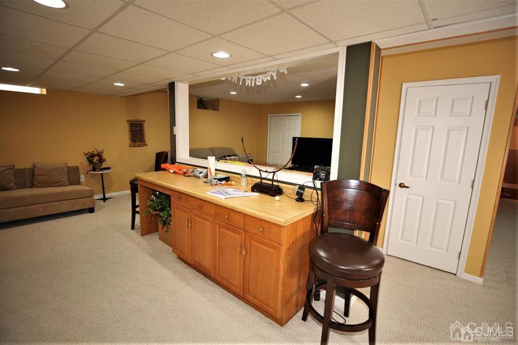 49 Harwood Road Monroe Township, NJ 08831 - Photo 49 of 73 a room with furniture a flat screen tv and a table