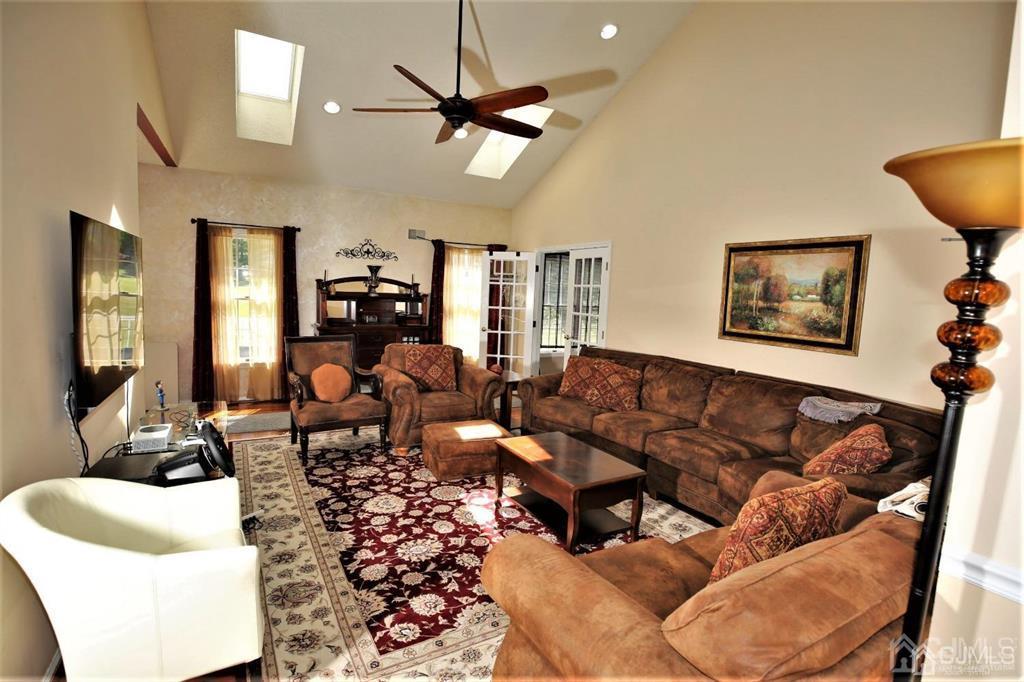 49 Harwood Road Monroe Township, NJ 08831 - Photo 5 of 73 a living room with furniture kitchen and a chandelier