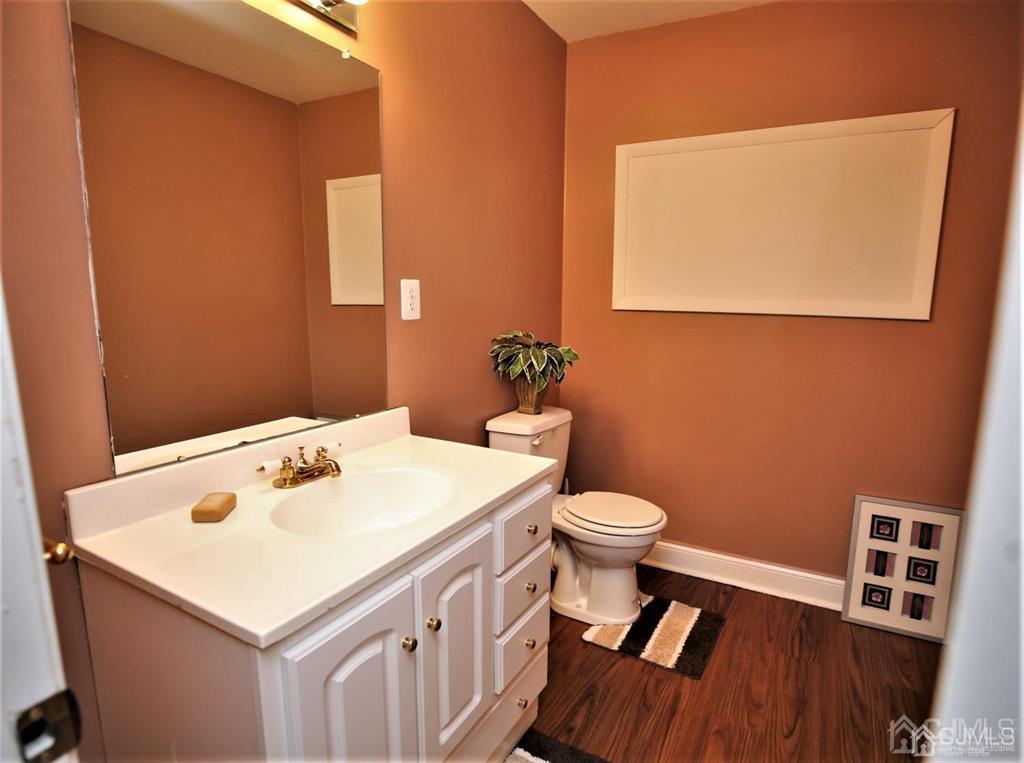 49 Harwood Road Monroe Township, NJ 08831 - Photo 53 of 73 a bathroom with a sink a toilet and a mirror
