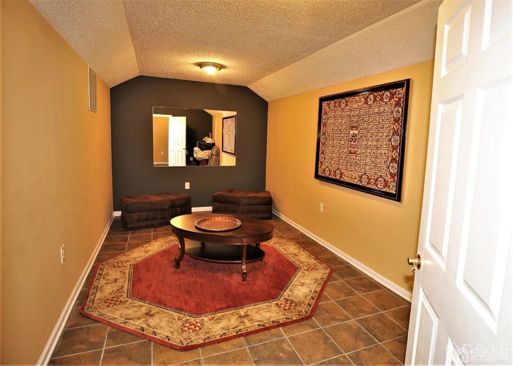 49 Harwood Road Monroe Township, NJ 08831 - Photo 54 of 73 a living room with a couch and a rug