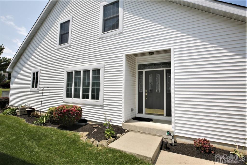 49 Harwood Road Monroe Township, NJ 08831 - Photo 60 of 73 a view of a house with a small yard and a large window