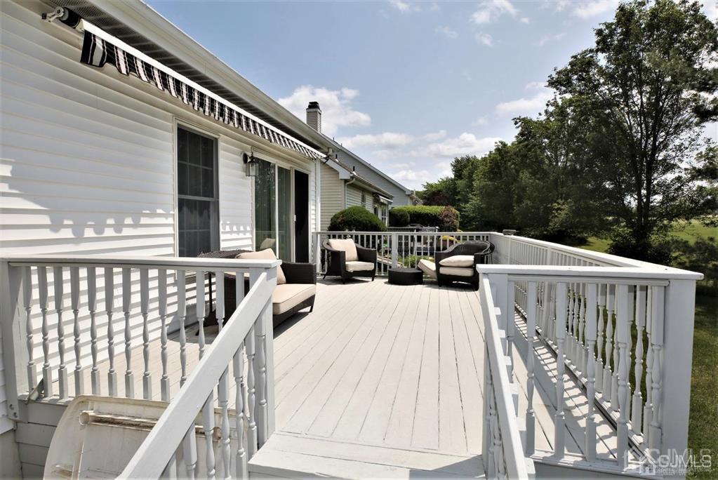 49 Harwood Road Monroe Township, NJ 08831 - Photo 64 of 73 a view of balcony with furniture and trees