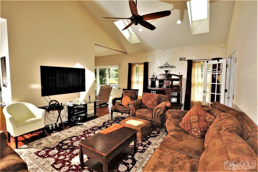49 Harwood Road Monroe Township, NJ 08831 - Photo 7 of 73 a living room with furniture and a flat screen tv