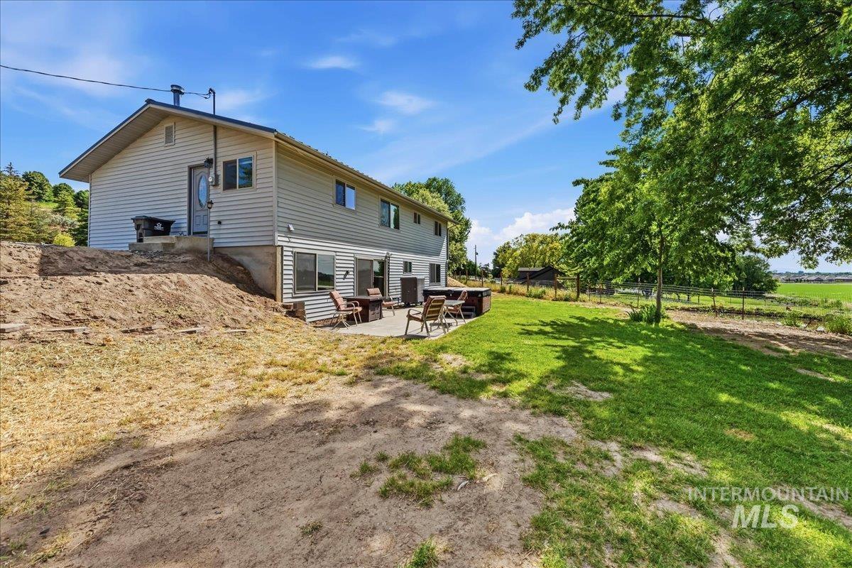 6323 Foothill Road Star, ID 83669 - Photo 32 of 50 Split-level residence featuring siding exterior, a concrete patio, and a tiered backyard